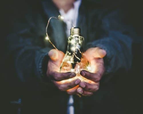 Business man holding light bulb, entrepreneurship, online business, scale, business growth
