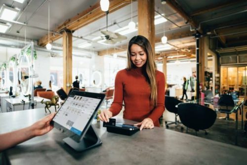 Woman paying at POS. Entrepreneurship, online business, scale, business growth